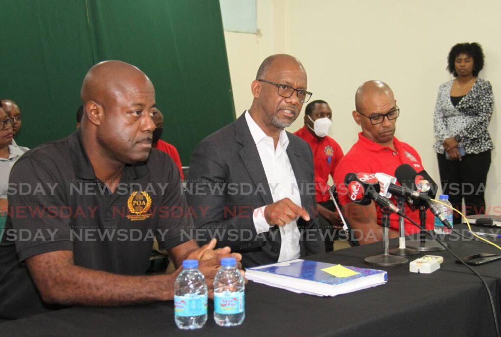 Public Service Association (PSA) president Leroy Baptiste speaks to the media during a press conference at the PSA building on Abercromby Street, Port of Spain. Also in the photo are president of the Prison Officers Association Ceron Richards, left, and president of the Fire Services Association Leo Ramkissoon.  Photo by Ayanna Kinsale