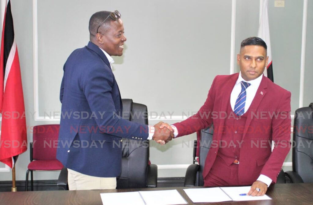 CORDIAL: Head of the Police Social Welfare Association acting ASP Gideon Dickson, left, in a meeting with Chief Personnel Officer Dr Darryl Dindial earlier this year. FILE PHOTO 