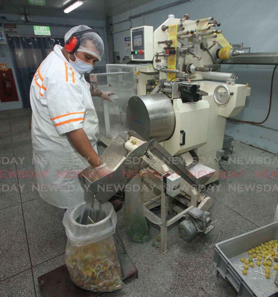 An employee sorts candy at KC Confectionary Ltd, Couva. KC is the TT Chamber of Industry and Commerce's 2022 Internationally-Known, T&T-Owned Company of the Year. - ANGELO MARCELLE