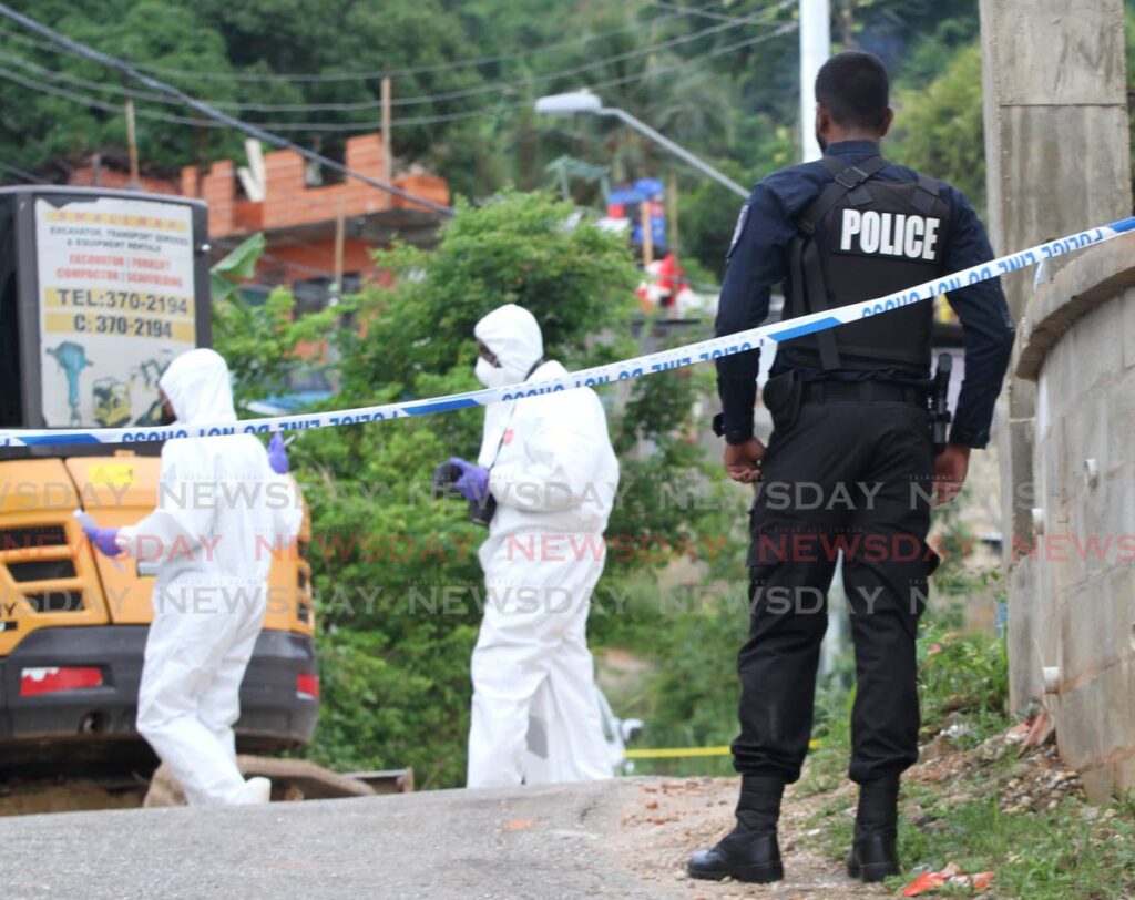 Crime Scene Unit officers gather evidence at the murder scene in Morvant on November 25. File Photo by Ayanna Kinsale