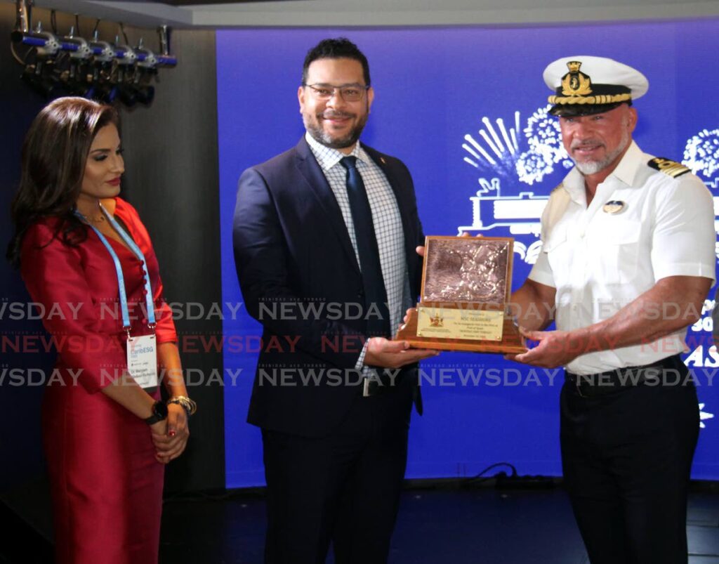 Minister of Tourism, Culture and the Arts Randall Mitchell presents captain Dino Sagani with a token of appreciation aboard the MSC Seashore at the Cruise Ship Complex, Port of Spain, while Principal Medical Officer, Ministry of Health, Dr Maryam Abdool-Richards looks on. - Photo by Ayanna Kinsale 