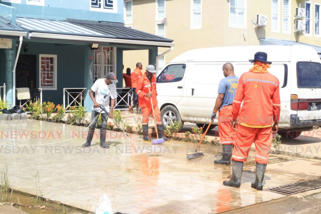 Members of the Defence Force, HDC Facilities Management and MTS were on hand to help residents of Real Springs, Valsayn South, with clean-up on Wednesday. Photo by Roger Jacob