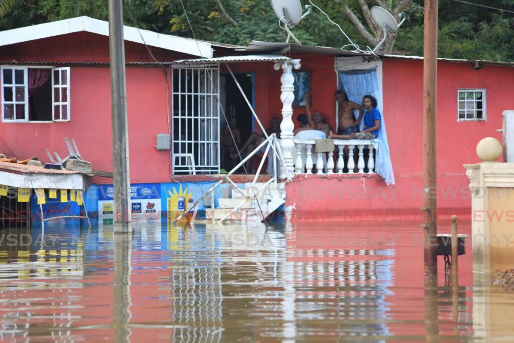 For the fifth day in a row, residents of Bamboo No 2, Valsayn South are unable to access their homes except by boat on Wednesday. Photo by Roger Jacob