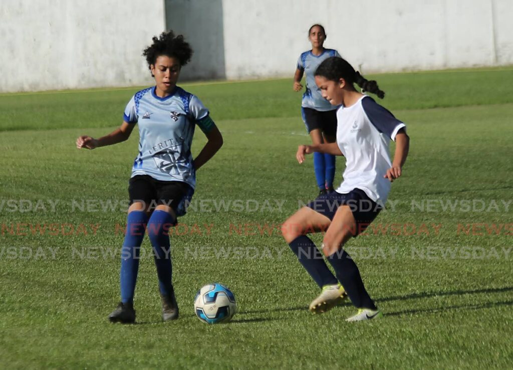 St Joseph’s Convent’s Hannah Vieira (L) vies for the ball during the SSFL Girls Division Coca-Cola Intercol final against Holy Name Convent, on Wednesday, at the St Mary’s Grounds, St Clair. - SUREASH CHOLAI