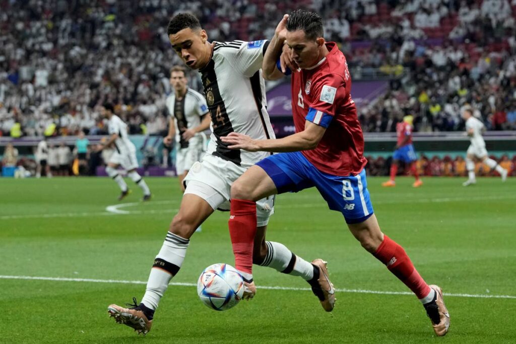 Germany's Jamal Musiala (L) and Costa Rica's Bryan Oviedo battle for the ball during the World Cup group E match at the Al Bayt Stadium in Al Khor , Qatar, on Thursday. (AP Photo) 