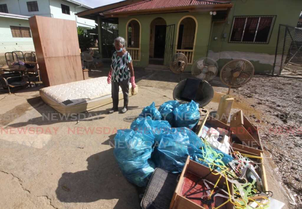 ALONE VS FLOOD MESS:
Gorlin Ramsingh, 73, stands surrounded by flood-damaged items from her home in her yard on Temple Street, Bamboo No 2, Valsayn South on Friday. Newsday understands that Ramsingh has had to face the clean-up effort on her own. - Angelo Marcelle