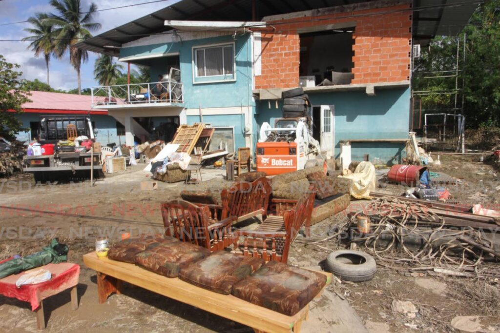 FILE PHOTO: In a common scene at Bamboo No 2, Valsayn South on December 2, flood damaged furniture and appliances are laid out in the front yard of a home during clean-up efforts. - 