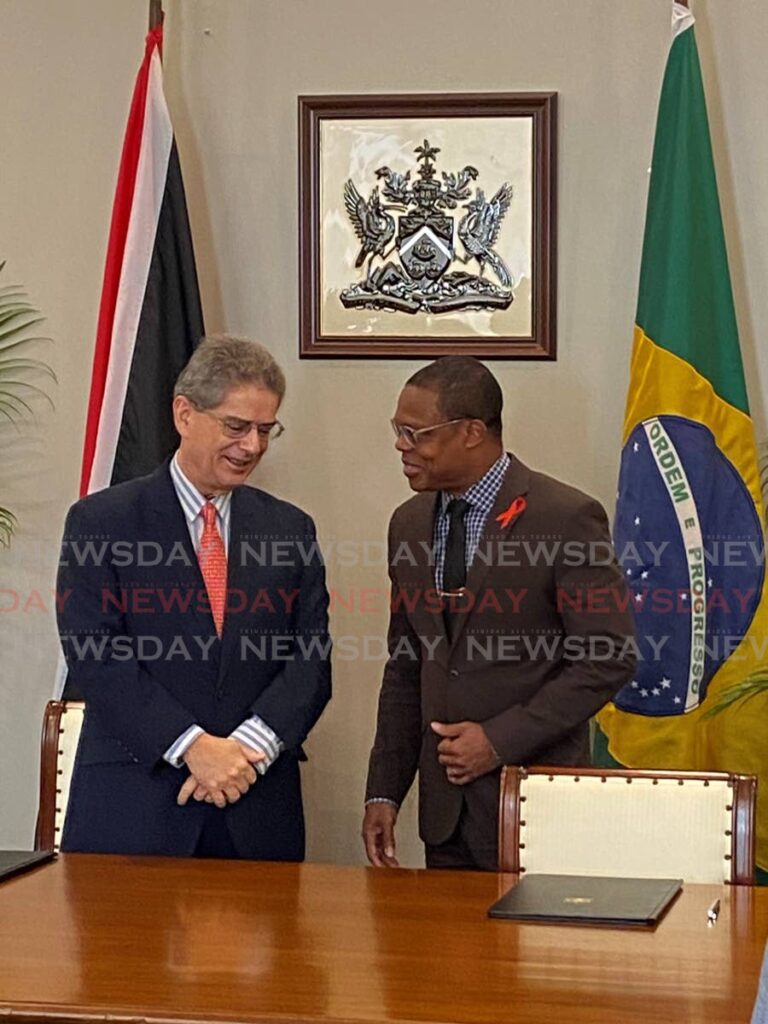 Brazilian Ambassador Rodrigo do Amaral Souza and Minister of Foreign Affairs Amery Browne at the official vaccine handover at the ministry's office. - Photo by Nicholas Maraj