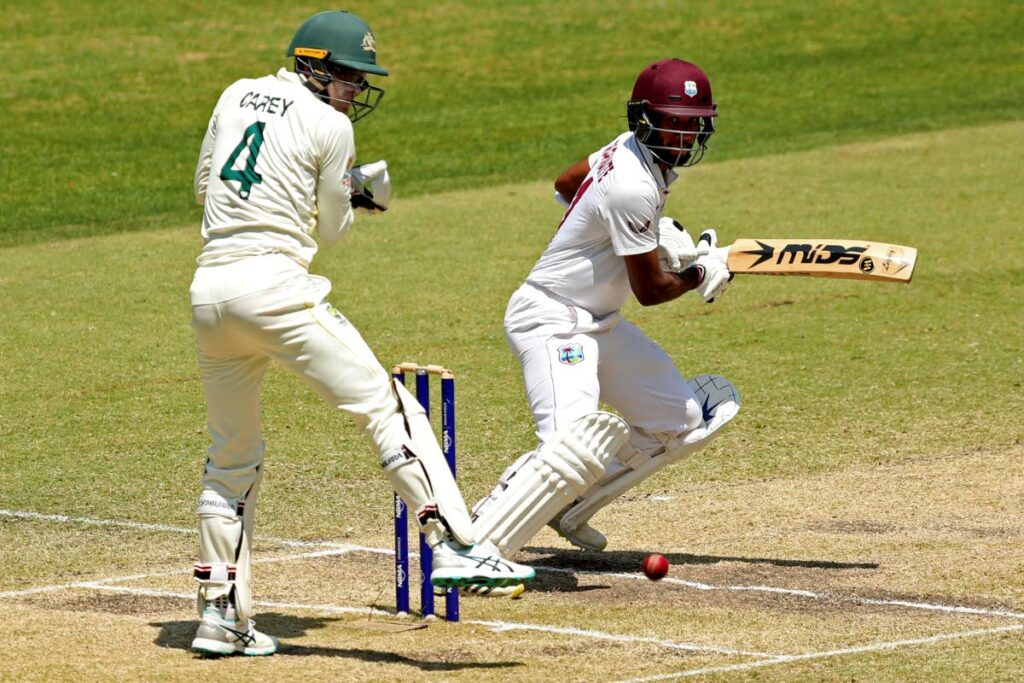 West Indies' Kragg Brathwaite, right, plays a shot past Australia's Alex Carey on the 3rd day of their first Test in Perth, Australia, on Saturday. (AP Photo) 