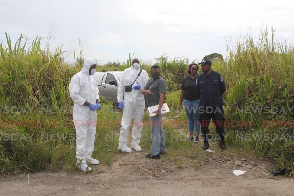 Police crime scene officers investigate the murders of Anita Jagdeo and Amar Randy Ramdass whose bodies were found in a car of Factory Road, Chaguanas on December 4. - LINCOLN HOLDER