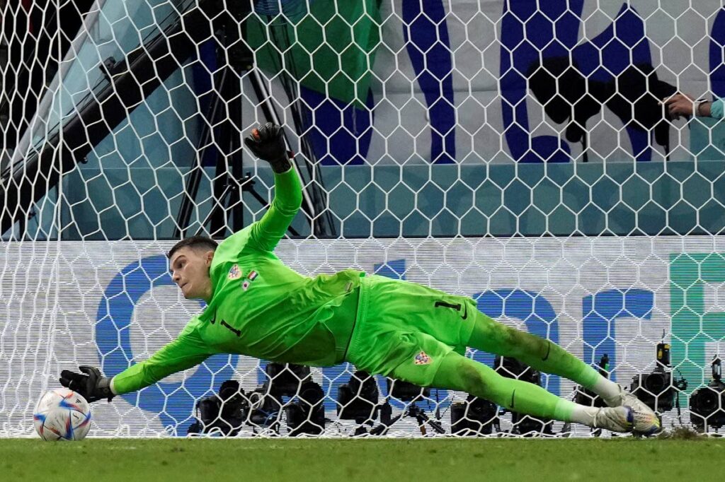Croatia's goalkeeper Dominik Livakovic saves a penalty kick by Japan's Kaoru Mitoma during the World Cup round of 16 match at the Al Janoub Stadium in Al Wakrah, Qatar, on Monday. (AP Photo) - 