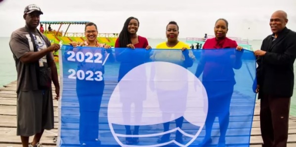PROUD MOMENT: (from left) Blue Flag awardee Ronnie Elliott, Green T&T's Michelle Lewis, Tourism Secretary Tashia Burris, Tobago Tourism Agency Ltd (TTAL) director Avion Hercules, TTAL product development officer Kirsten Cowie-Irvine, and Blue Flag awardee Dexter
Black with the Blue Flag on Pigeon Point Jetty. 