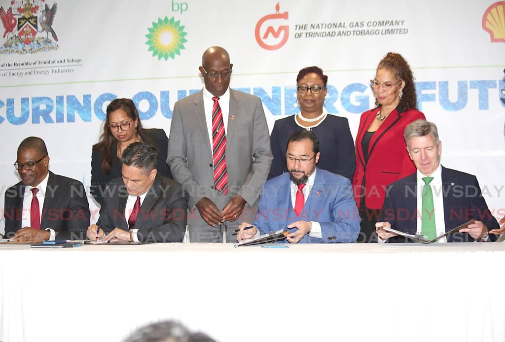 Prime Minister Dr Keith Rowley and government officials witness the signing of the heads of agreement of Atlantic LNG shareholders, from left, Shell TT country chairman Eugene Okpere, NGC president Mark Loquan, Energy Minister Stuart Young and bpTT president David Campbell at Hilton Trinidad, Port of Spain on Tuesday. - File photo/Sureash Cholai