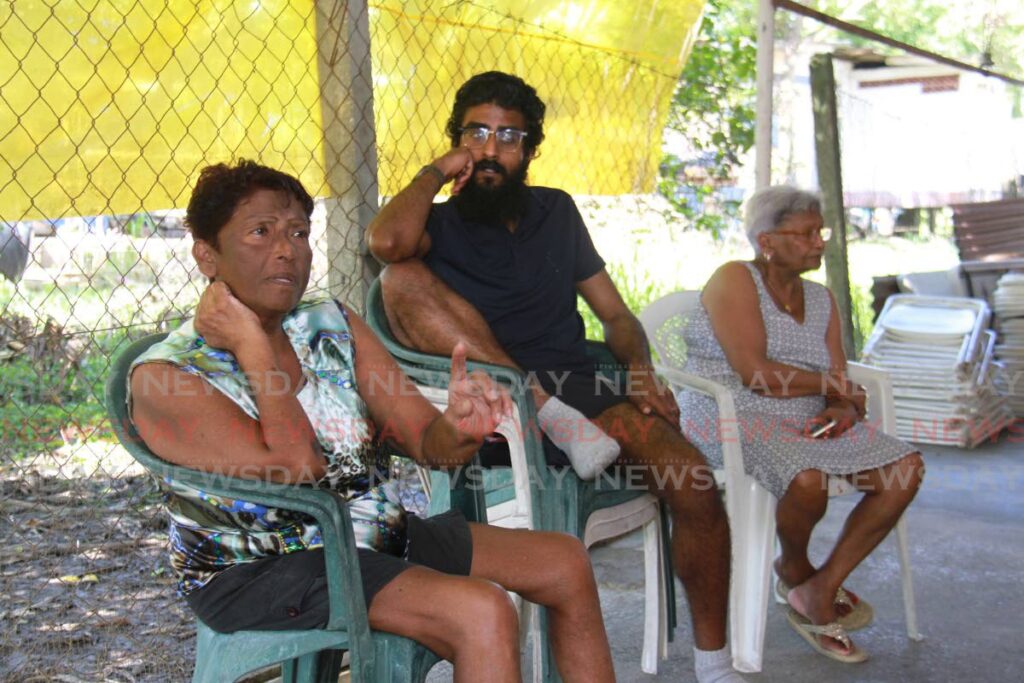 Chandernagore Road grandmother, Carmelita Ramdass (left), speaks with Newsday on Tuesday while the family gathered at their home. Her grandson Randy Ramdass' body was one of two double homicide, that was found in a car on Sunday. Photo by Marvin Hamilton