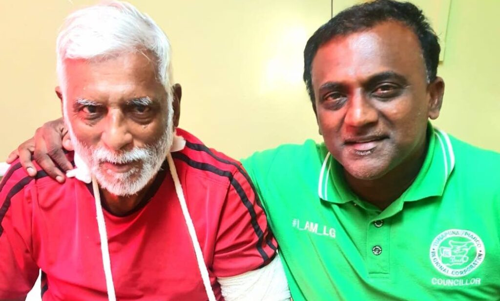 Former sport minister Manohar Ramsaran, left, is hugged by Kelly Village/Warrenville councillor and Munroe Road Cricket Club chairman Samuel Sankar, while recovering from injuries at Mt Hope Hospital last week.