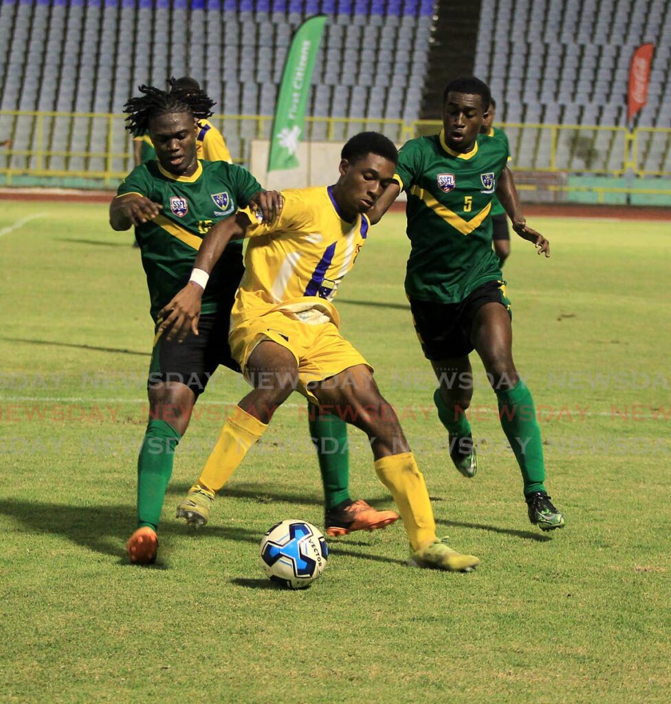 Fatima’s Khiba Romany (C) battles for the ball against St Benedict’s Ephraim Brown (L) and Joshua Demas during the Coca-Cola Intercol final, on Wednesday, at the Hasely Crawford Stadium, Port of Spain. Photo by Roger Jacob