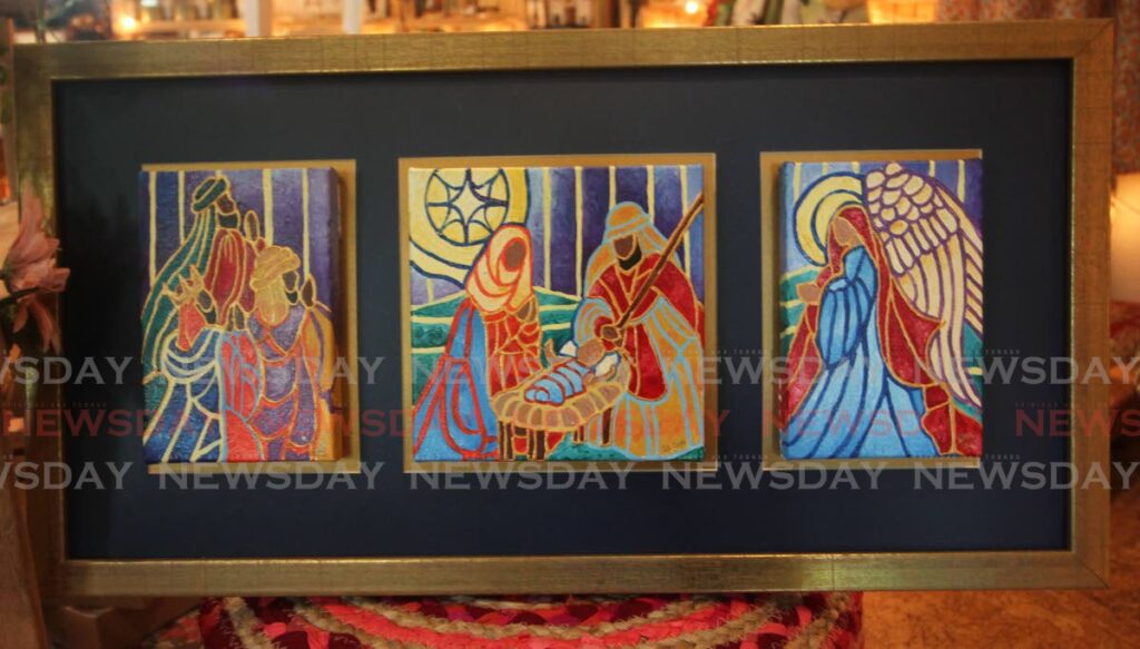 A three-panel painting depicting Christmas scenes by artist Damian Moore.  File photo/Angelo Marcelle