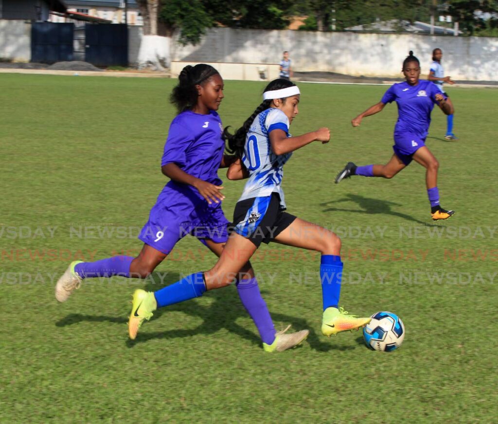 Holy Name Convent’s Isabella Ramdeen (R) controls the ball as Five Rivers Secondary’s Odella Wilson tries to defend during the SSFL Girls Intercol semi-final, on Thursday, at the St Mary’s Grounds, St Clair.  - ROGER JACOB