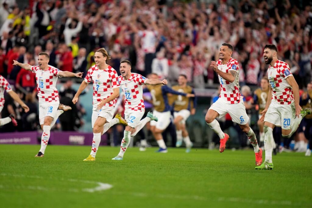 Croatia players celebrate defeating Brazil in the World Cup quarterfinals on Friday in Qatar.  - AP