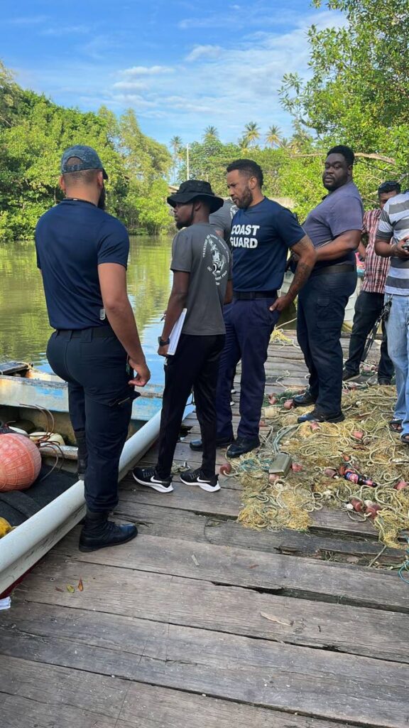 Coast Guard officers near the Ortoire River, Mayaro, on Friday, where two-year-old Allon Ramdial went missing.