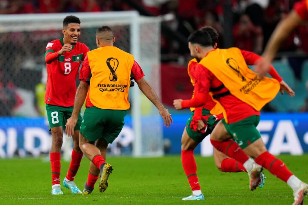 Morocco's Azzedine Ounahi, left, celebrates with his teammates after winning the World Cup quarterfinal footbal match against Portugal, at Al Thumama Stadium in Doha, Qatar, Saturday. - AP Photo