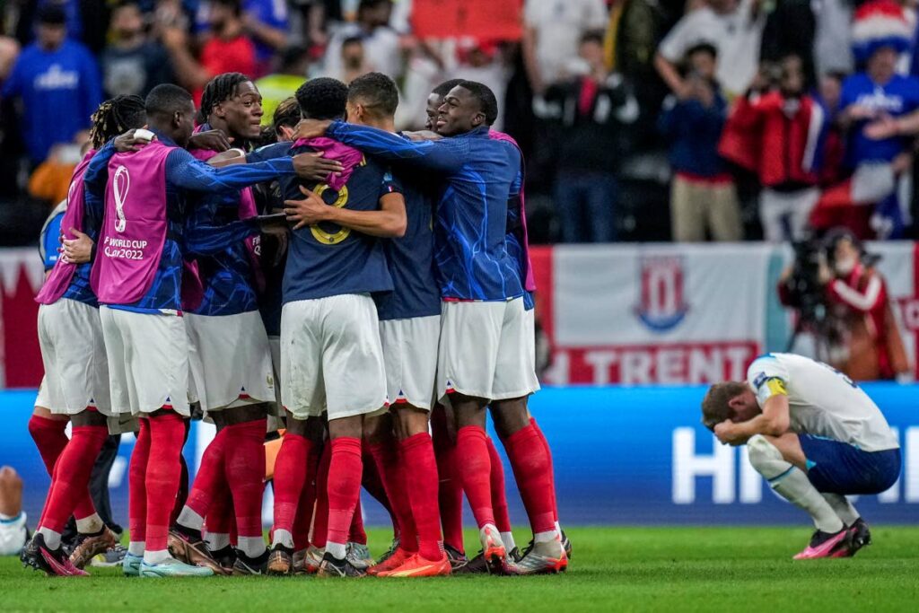 England's Harry Kane, right, reacts as France players celebrate their team victory over England at the end of the World Cup quarterfinal match between England and France, at the Al Bayt Stadium in Al Khor, Qatar, on Saturday. (AP PHOTO) - 