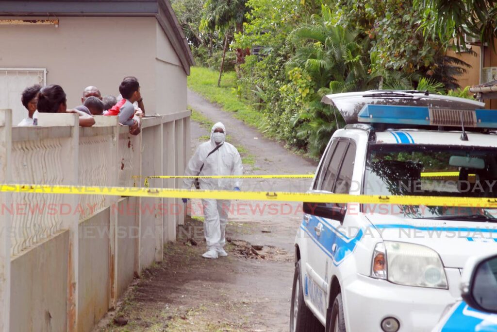 In this December 12 crime scene investigators at the scene of the murder of businessman and former police officer Syed Mohammed at his Katwaroo trace Penal home. Photo by Lincoln Holder