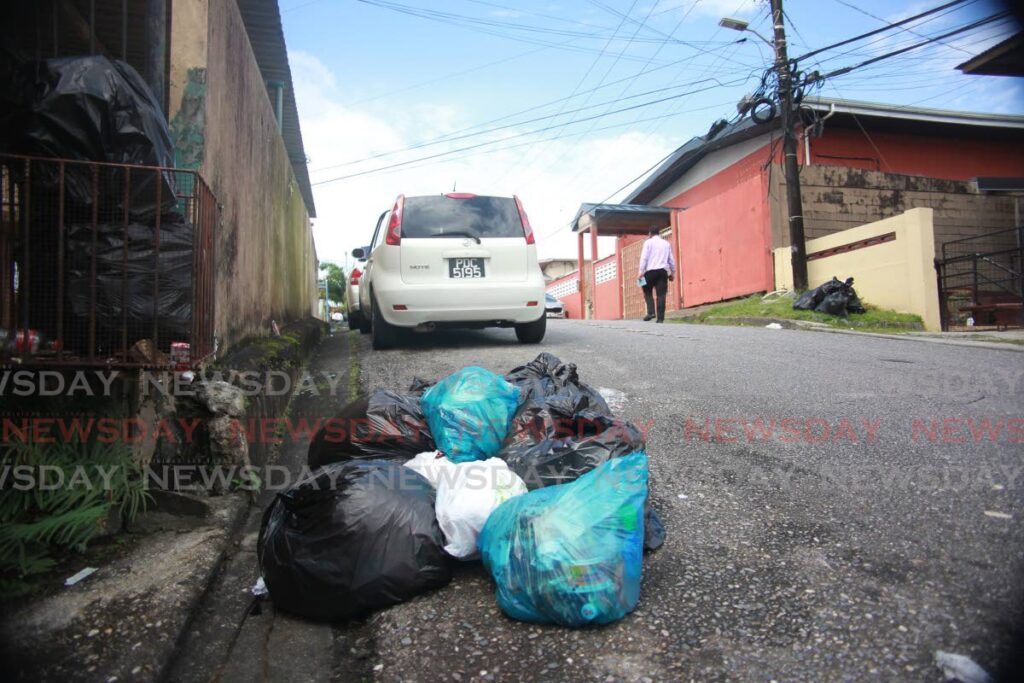 Garbage pile up on Robertson street San Fernando, residents are complaining about the inconsistent garbage removal by the San Fernando City corporation. Photo by  Lincoln Holder