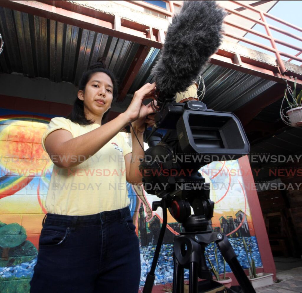 Filmmaker Rhonda Chan Soo prepares to capture footage at East Yard, Prince Street, Arima. - ANGELO MARCELLE