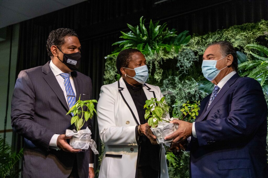  Ansa Merchant Bank chairman  Norman Sabga and managing director Gregory N. Hill (left) gift Planning and Development Minister Pennelope Beckles-Robinson,  basil and mint from the 'living wall' at the launch of the Caribbean Natural Capital Hub at Hyatt earlier this year. Photo courtesy Ansa Merchant Bank