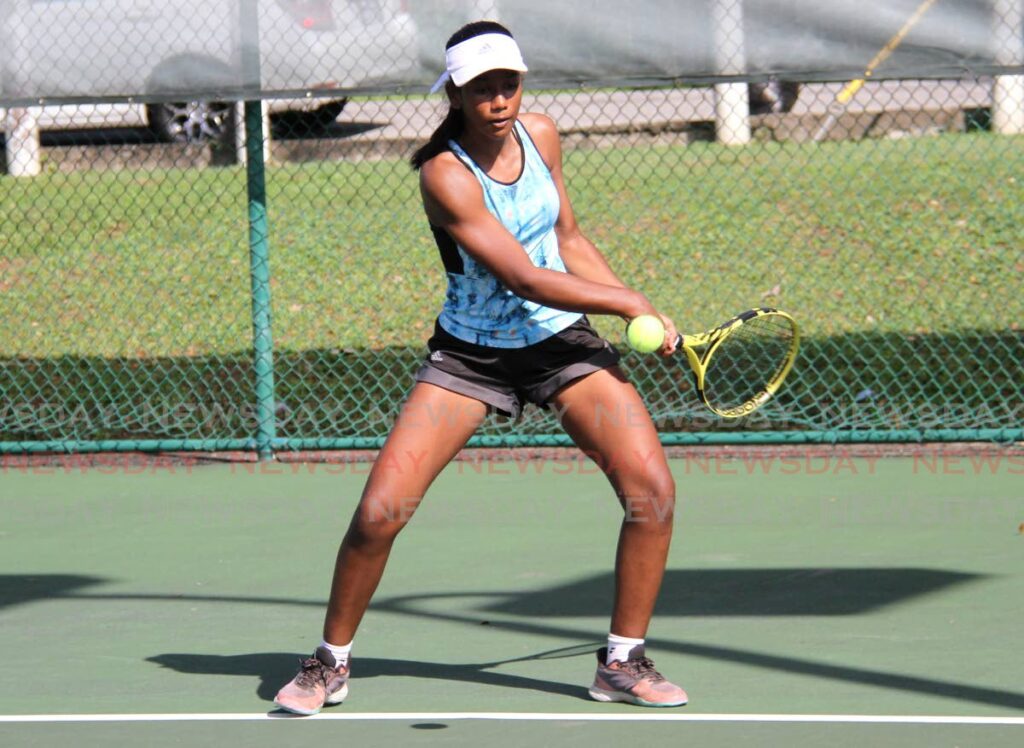 Brianna Harricharan returns the ball to Shaina Smith during the RBC Junior Tennis torurnament at the Eddie Taylor Public Courts, Nelson Mandela Park, St Clair on Friday. - AYANNA KINSALE