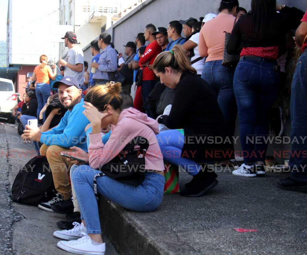 Venezuelan migrants gather outside the Immigration Division in Port of Spain hoping to get an extension to stay in this country legally on December 16.  - AYANNA KINSALE