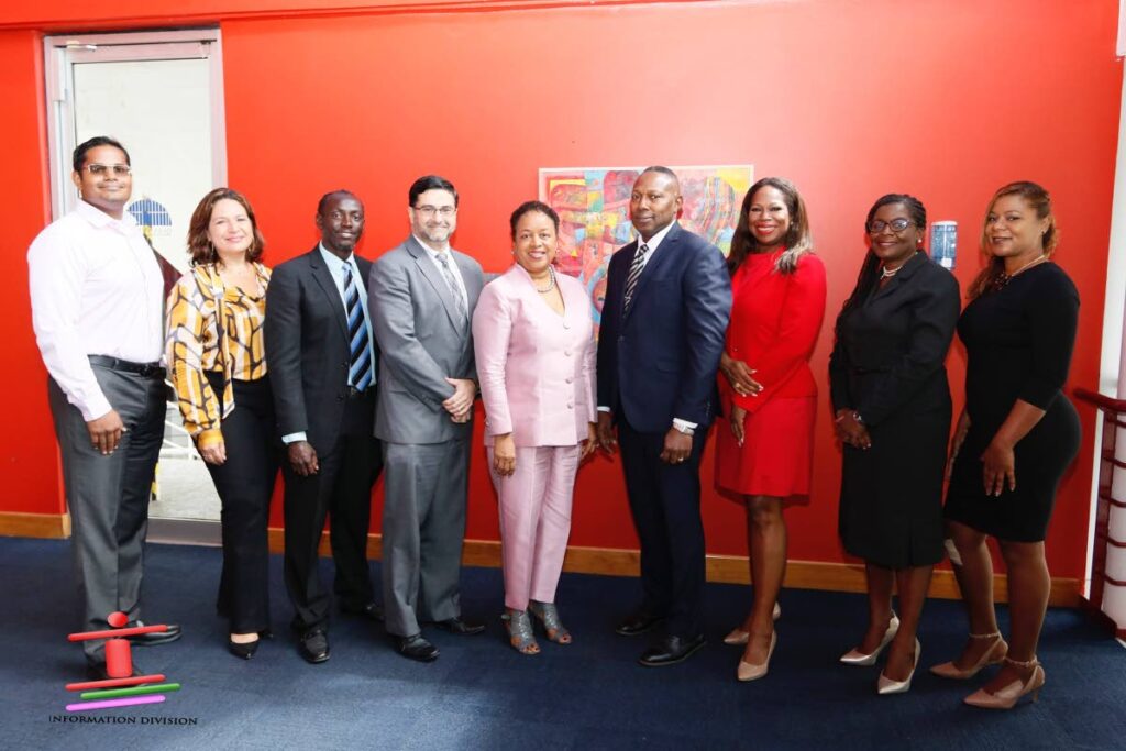  Public Administration Minister Allyson West, centre, with Mark Edghill, president of the Association of real Estate Agents, and members of the ministry at the launch of the portal for Property and Real Estate Services Division at Queen's Hall, St Ann's on Wednesday. Photo courtesy the Ministry of Public Administration. - 