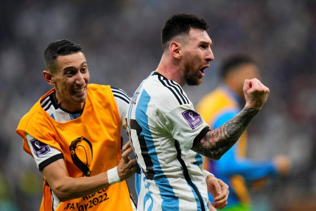 Argentina's Lionel Messi, right, and Angel Di Maria celebrate a goal during the World Cup final against France at the Lusail Stadium in Lusail, Qatar, Sunday, - AP