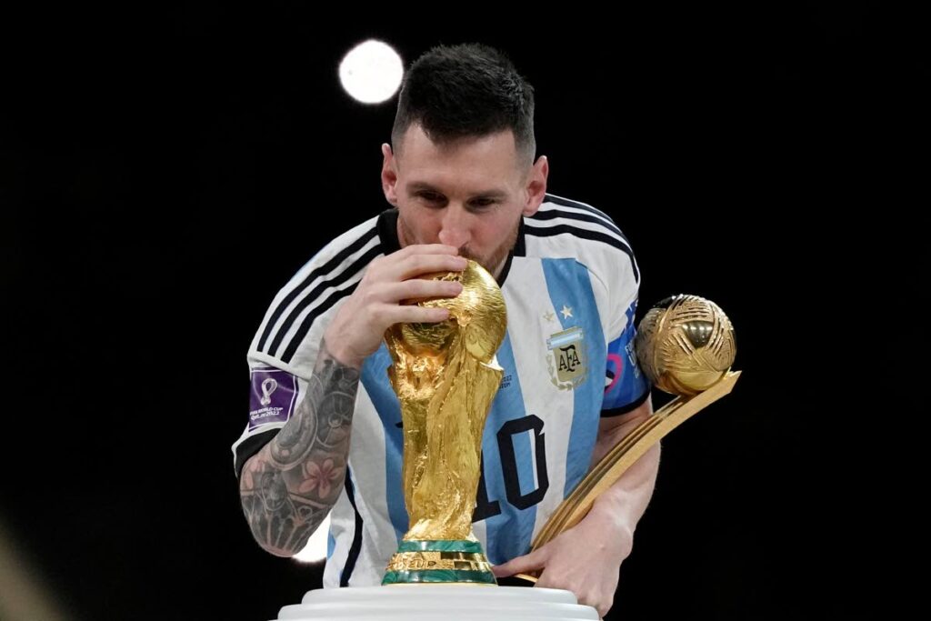 Lionel Messi kisses the trophy after winning the World Cup final soccer match between Argentina and France. AP Photo - 