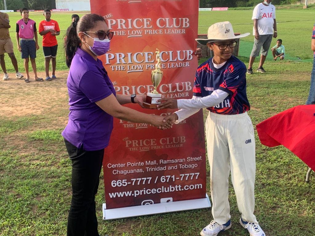 TT Under-13 cricketer Shaan Ramtahal, right, was one the team's top players in the last match of the series against Guyana on Saturday. In this file photo, Ramtahal receives an award at the National Cricket Centre in Balmain, Couva. 
