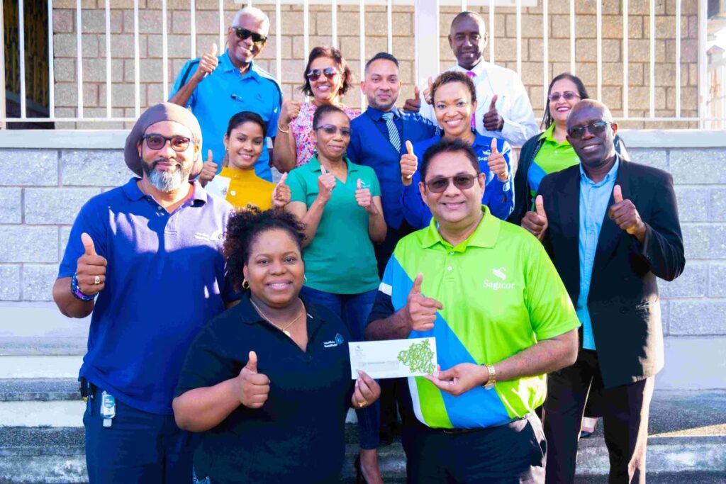 Members of the sales team at Sagicor's Wayne Mohammed branch in San Fernando engaged with the students of Rhe’s Homework Centre. The husband and wife team that manage the centre were presented with funds to buy furniture for the centre that will support the needs of the students in the district. Photo courtesy Sagicor