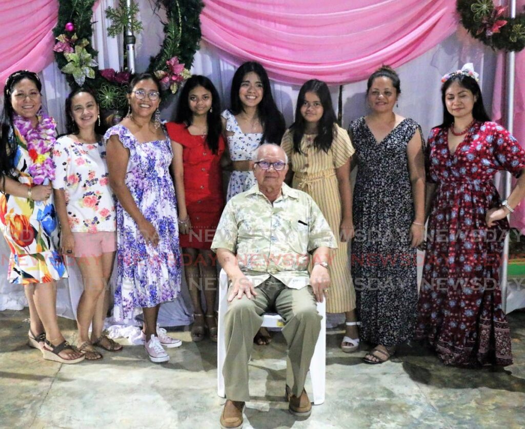 Filipino consular general of TT Dr Noe Jaen, centre, poses for a picture with relatives during the consulate's annual Christmas party at the Airport Suite Hotel, Piarco, last Saturday night - Shane Superville