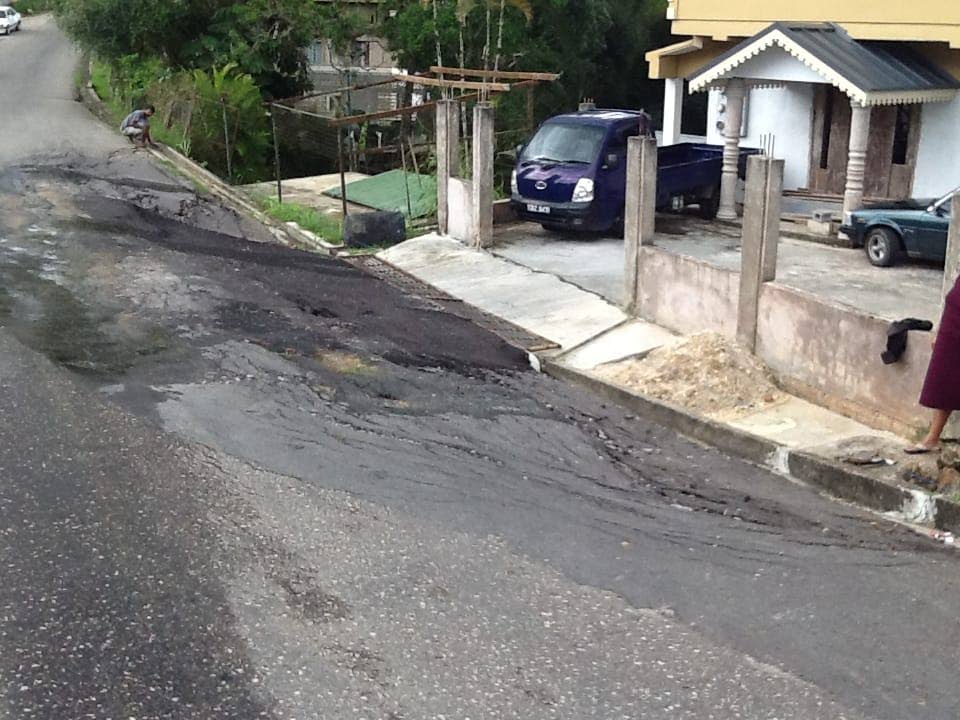 SLIPPING AWAY: This photo shows the road slippage outside the Sahadath family home in Princes Town. Photo courtesy The Sahadath family.
