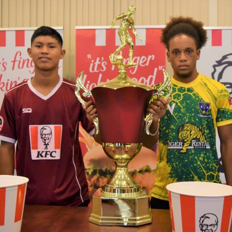 St Benedict's U18 captain Cunnielus Hannaway, right, and DC Caesar Fox's skipper Raydon Krammer with the 2022 KFC Goodwill title before Friday's final in Guyana.  Photo courtesy Petra Organisation