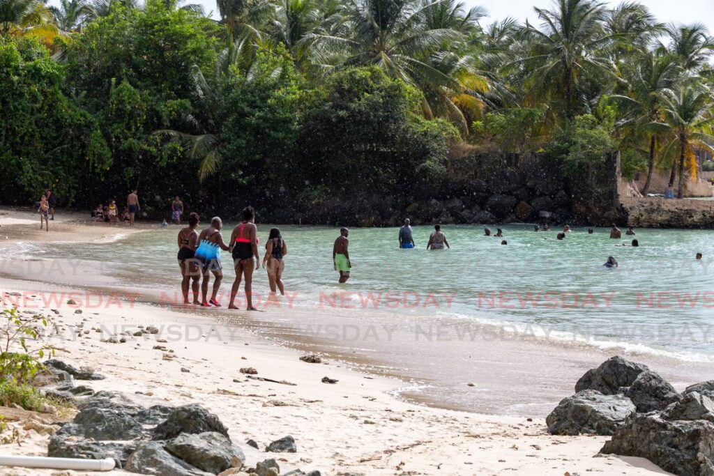 People take a chance for a sea bath at Swallow's Beach, Tobago, on Christmas Day. - David Reid
