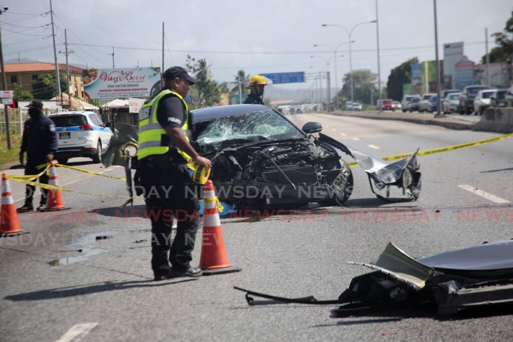 FILE PHOTO: Police manage the scene of a fatal accident on the Churchill Roosevelt Highway, near UWI on Tuesday. - 