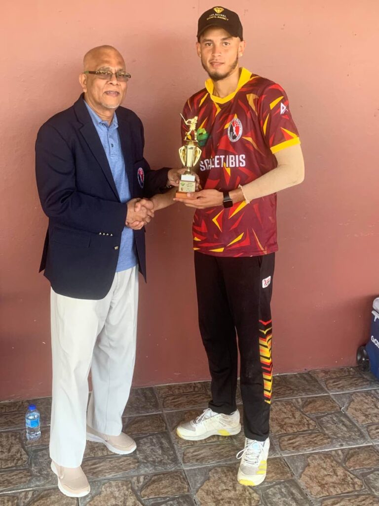Scarlet Ibis' Sion Hackett receives the man of the match award from TTCB president Azim Bassarath after his team's 25-run victory over Hummingbirds in the Namalco U-23 Cup opening match at National Cricket Centre in Balmain, Couva, on Wednesday.  - Courtesy TTCB