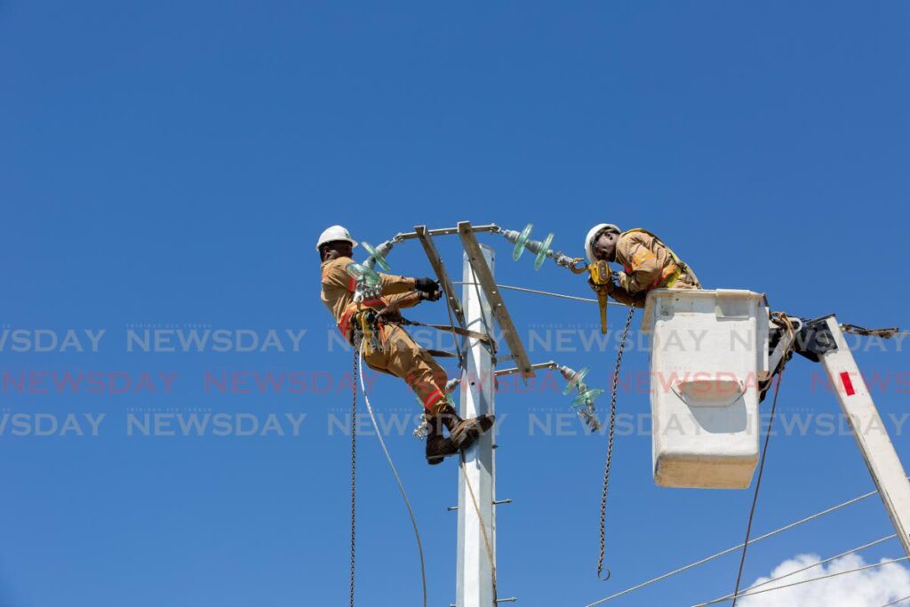 TTEC workmen change poles at Lambeau Street, Lambeau, Tobago, on February 4. - File Photo/David Reid