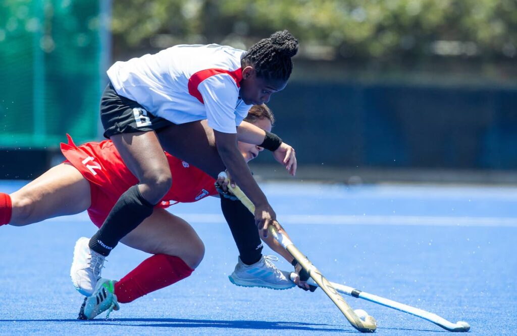 Trinidad and Tobago's Felicia King (front) battles for the ball with Peru's Paloma Larranaga during their Women's Pan American Cup match at Santiago, Chile on January 21, 2022. PHOTO COURTESY PAN AM HOCKEY. - 
