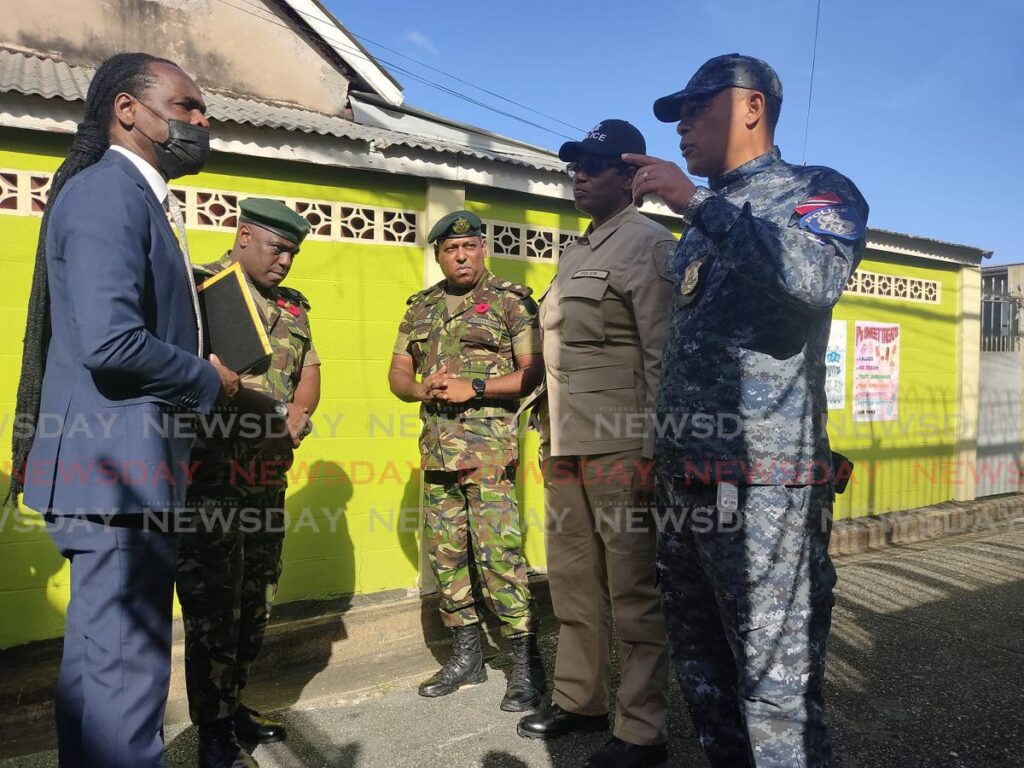 In this file photo, National Security Minister Fitzgerald Hinds, left, listens to Snr Supt of the Inter-Agency Task Force Oswain Subero, right, durng a visit to the Rose Hill RC Primary School, east Port of Spain, last November. Photo by Shane Superville