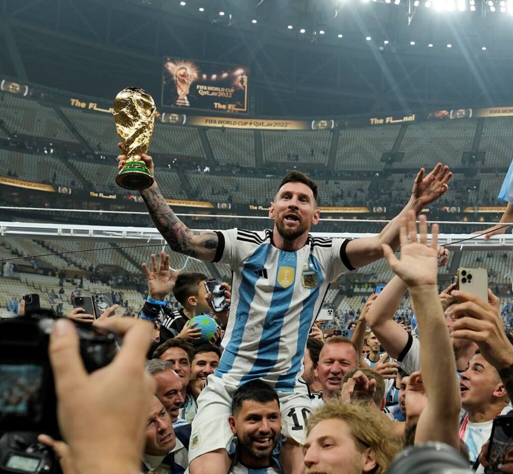 Argentina's Lionel Messi celebrates with the trophy after winning the World Cup final against France at the Lusail Stadium in Lusail, Qatar, last December. - AP