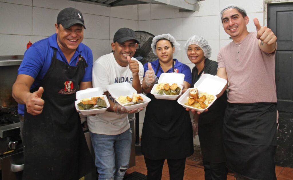 Andres Contreras, right,  and his staff at his Venezuelan dine-in and takeaway restaurant on Endeavour Road, Chaguanas. - Marvin Hamilton