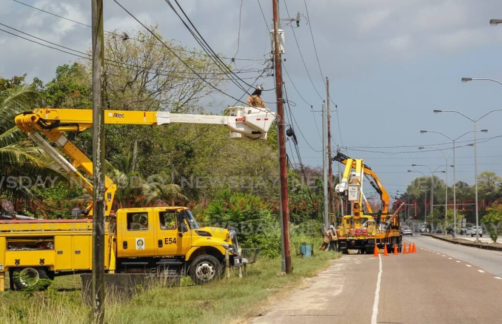 FILE PHOTO: Workers from TTEC conduct overhead powerline maintenance on the Churchill Roosevelt Highway in Cumuto, May 12, 2022. 