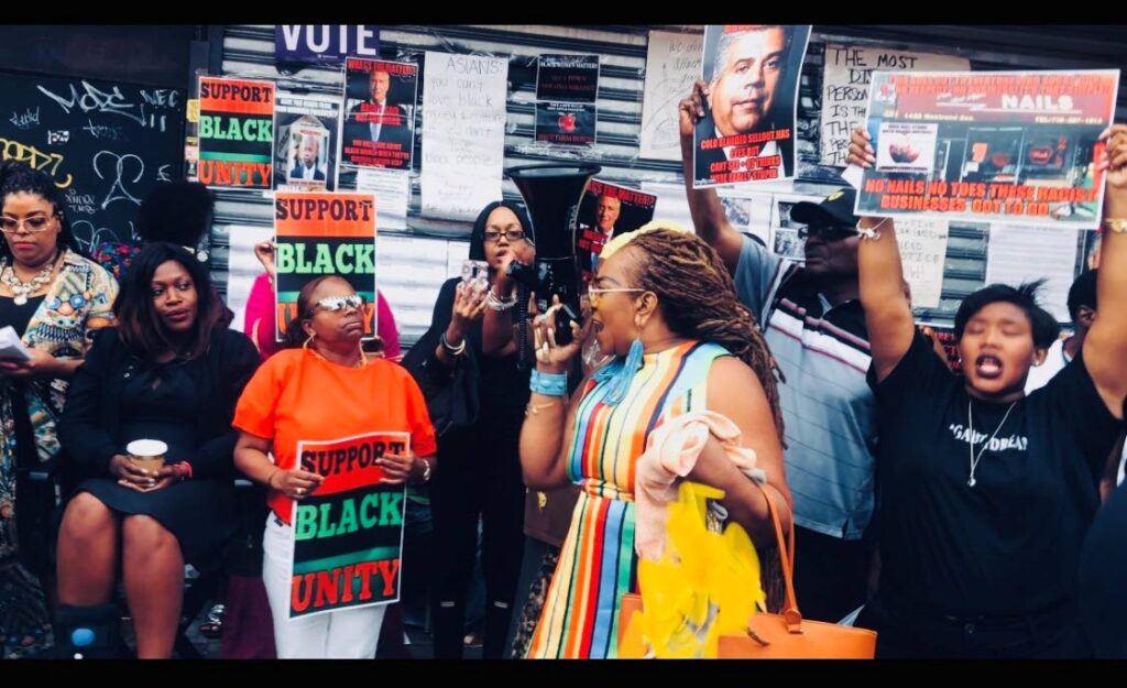 Jahmela Jacobson leading a protest after three black women were victimised and beaten by Asian nail technicians at a salon in Brooklyn in August 2018. 